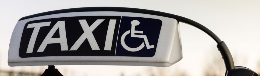 Photo of taxi sign with disabled wheelchair sign.
