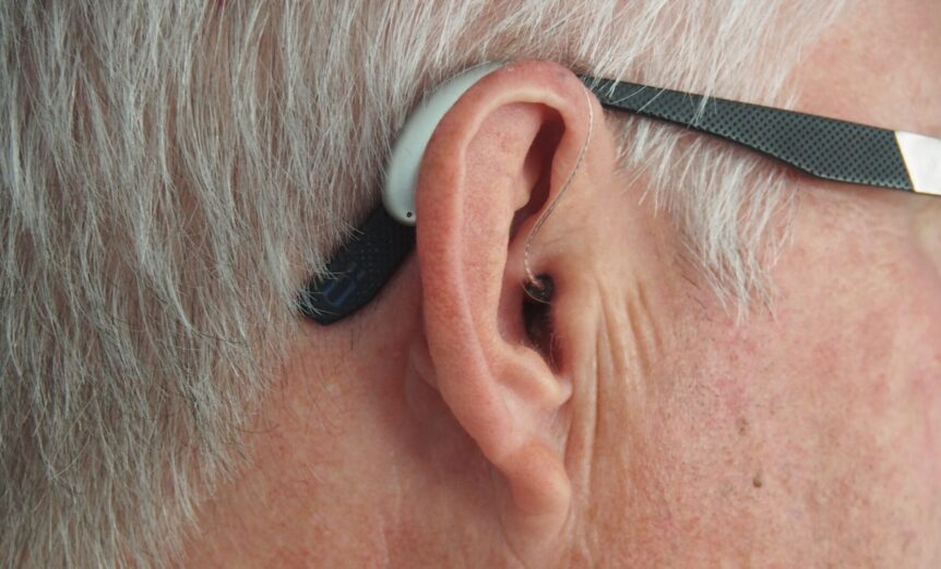 Photo of hearing aid on man's ear